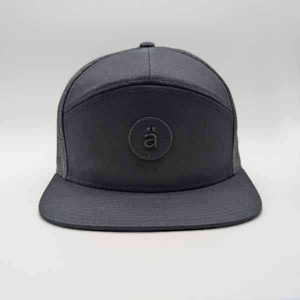 black cap with a logo on a light gray background